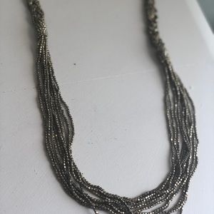 Long gold beaded and braided necklace